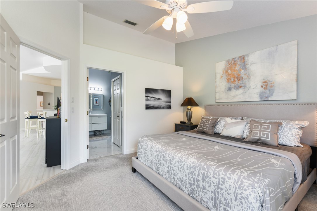 512 Islamorada Boulevard Punta Gorda, FL 33955 - Photo 35 of 46 a bedroom with a bed and a chandelier