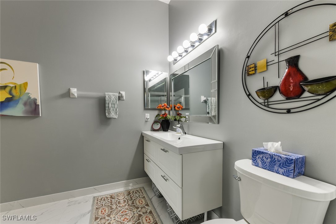512 Islamorada Boulevard Punta Gorda, FL 33955 - Photo 39 of 46 a bathroom with a toilet a sink and a mirror