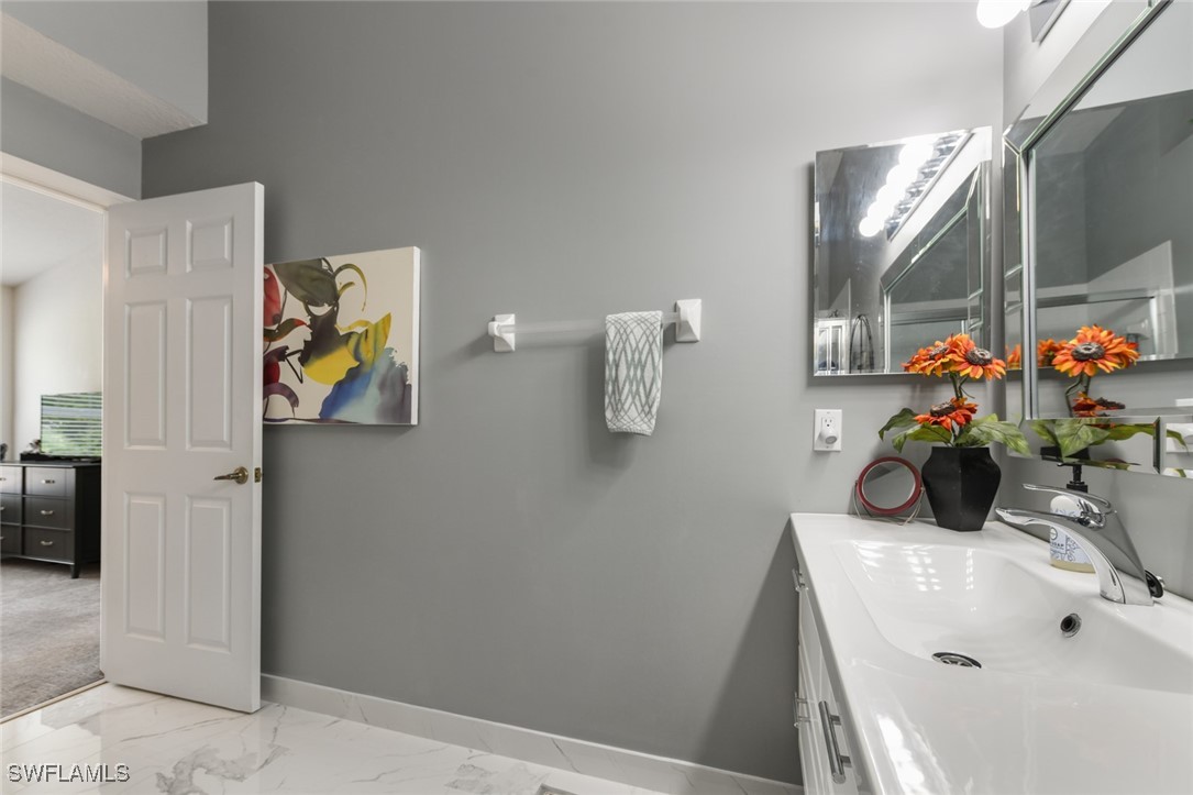 512 Islamorada Boulevard Punta Gorda, FL 33955 - Photo 40 of 46 a bathroom with a sink mirror and window