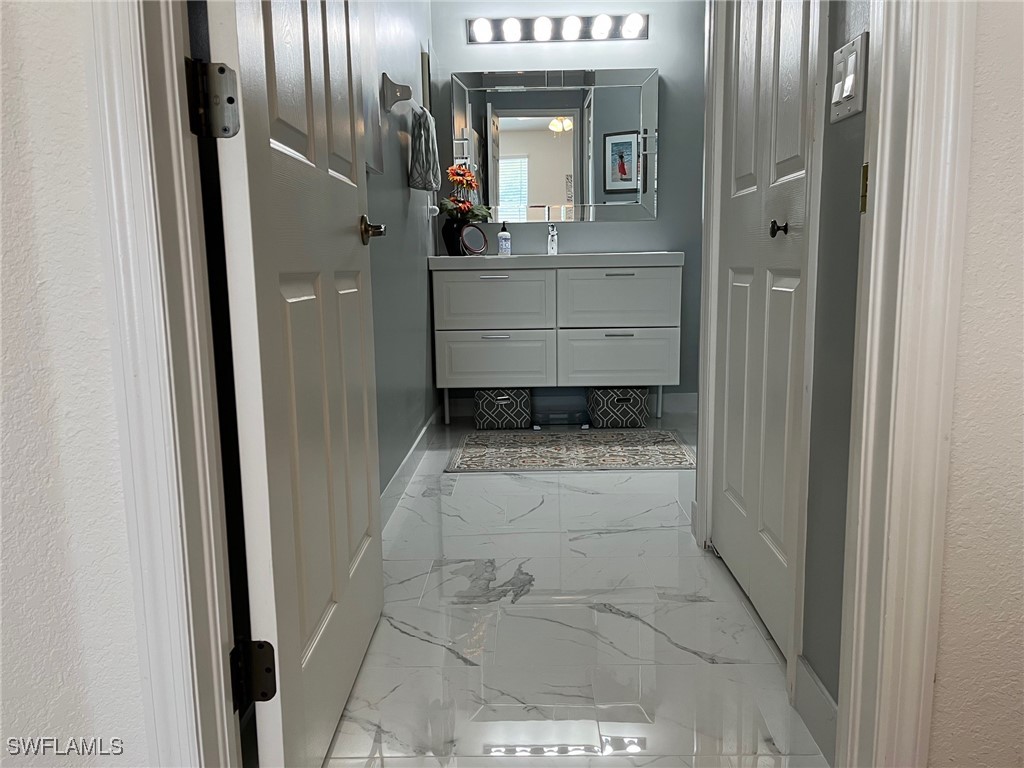 512 Islamorada Boulevard Punta Gorda, FL 33955 - Photo 41 of 46 a bathroom with a sink and mirror