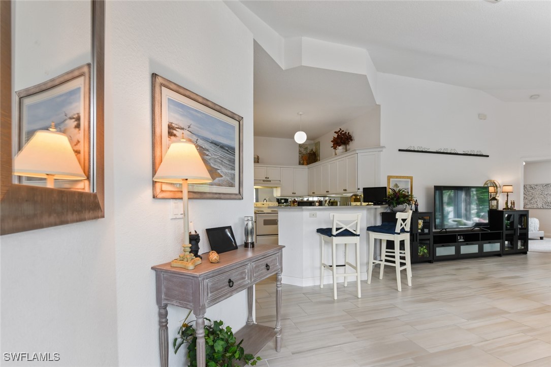 512 Islamorada Boulevard Punta Gorda, FL 33955 - Photo 5 of 46 a living room with furniture a wooden floor and a large window