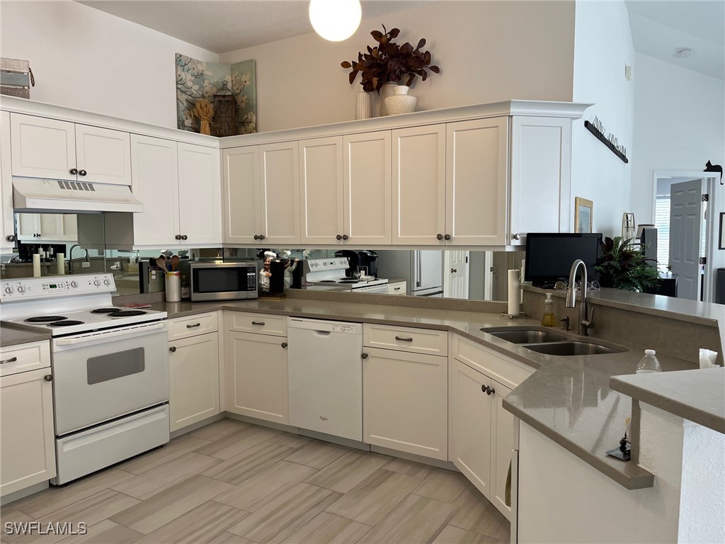 512 Islamorada Boulevard Punta Gorda, FL 33955 - Photo 6 of 46 a kitchen with stainless steel appliances granite countertop a sink stove and cabinets