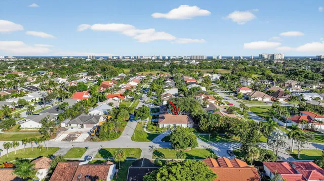 an aerial view of residential houses with outdoor space and swimming pool