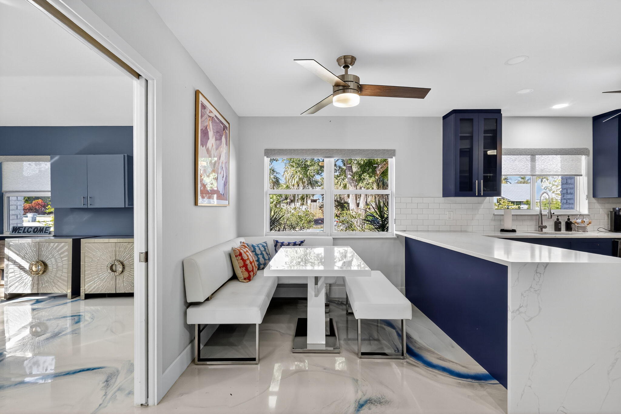 7598 West Country Club Boulevard Boca Raton, FL 33487 - Photo 45 of 103 a view of kitchen island with stainless steel appliances wooden floor dining table and chairs