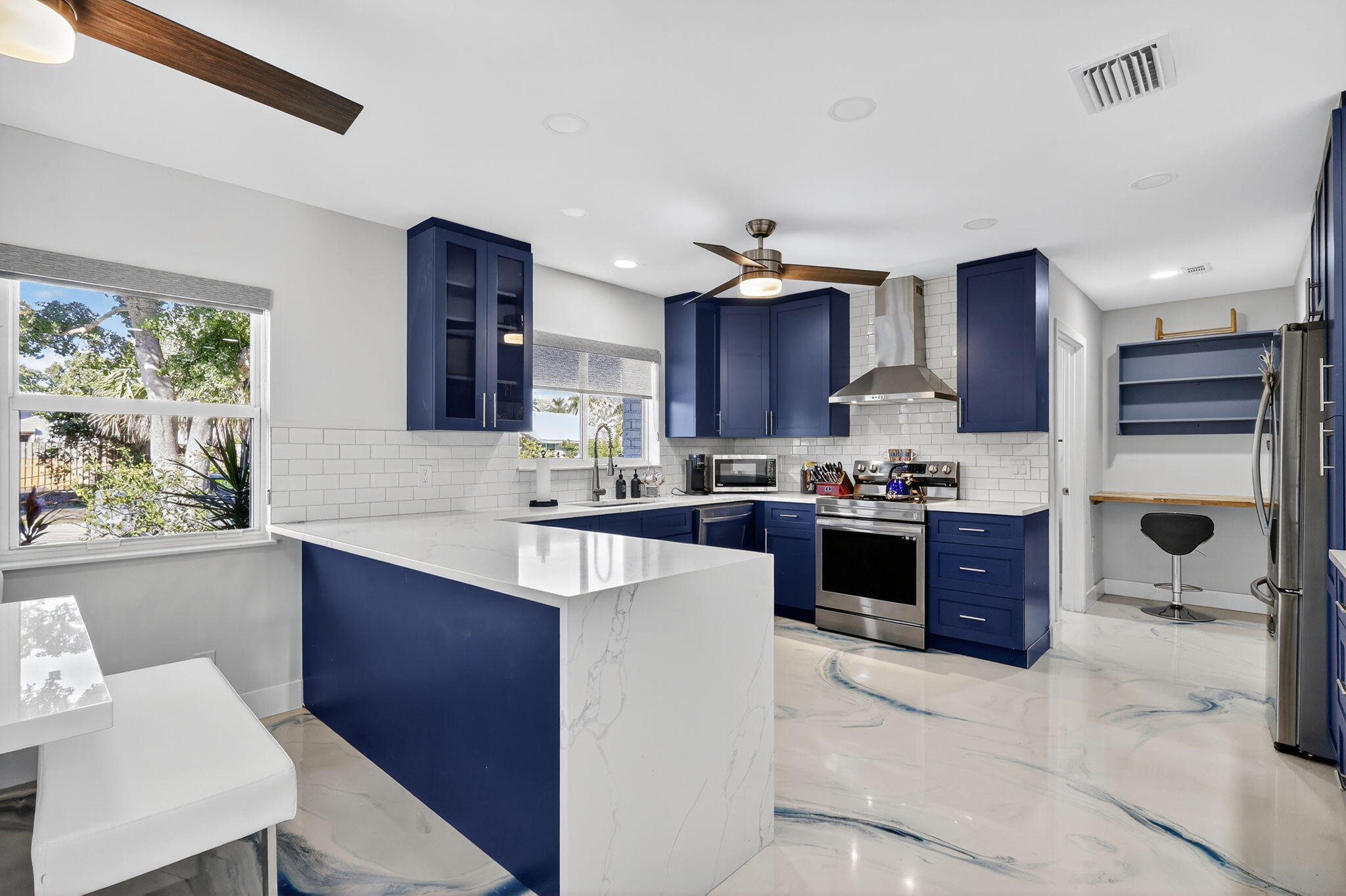 7598 West Country Club Boulevard Boca Raton, FL 33487 - Photo 54 of 103 a large kitchen with stainless steel appliances granite countertop a stove a sink dishwasher a refrigerator and a dining table with wooden floor