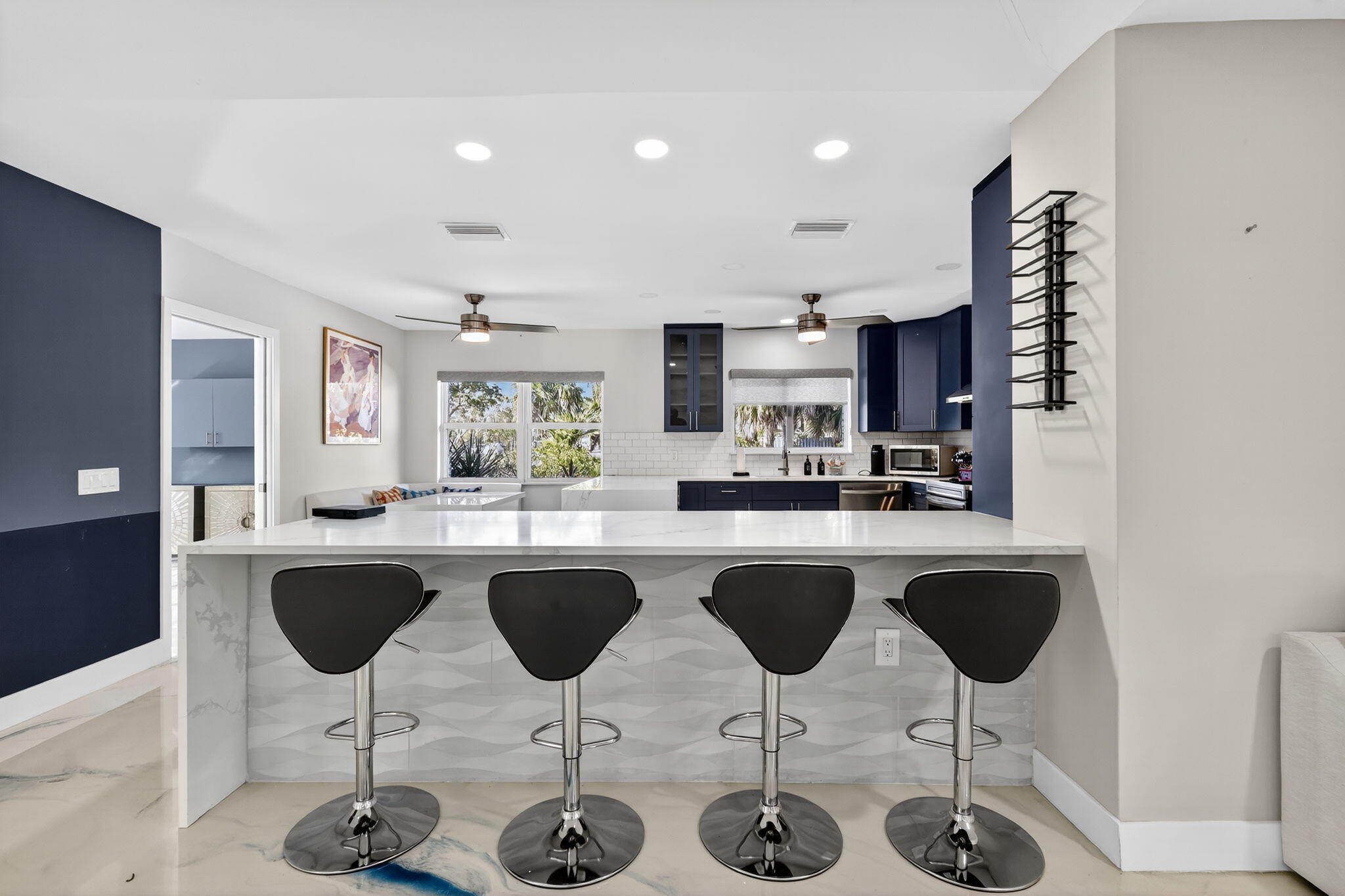 7598 West Country Club Boulevard Boca Raton, FL 33487 - Photo 55 of 103 a kitchen with stainless steel appliances granite countertop a table and chairs in it