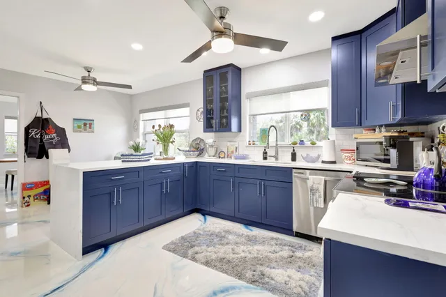 a front view of a house with garden and trees
