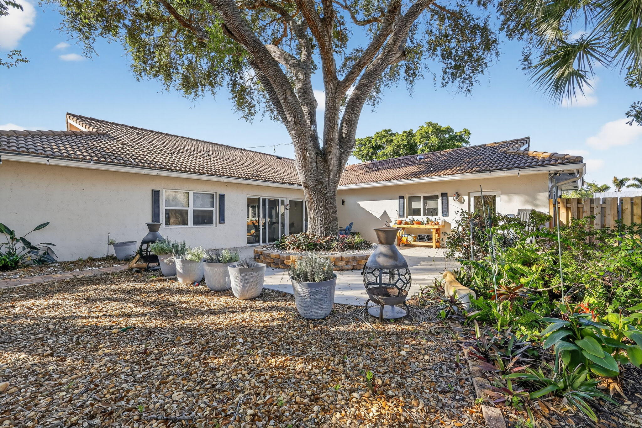 7598 West Country Club Boulevard Boca Raton, FL 33487 - Photo 90 of 103 a view of a house with backyard and sitting area