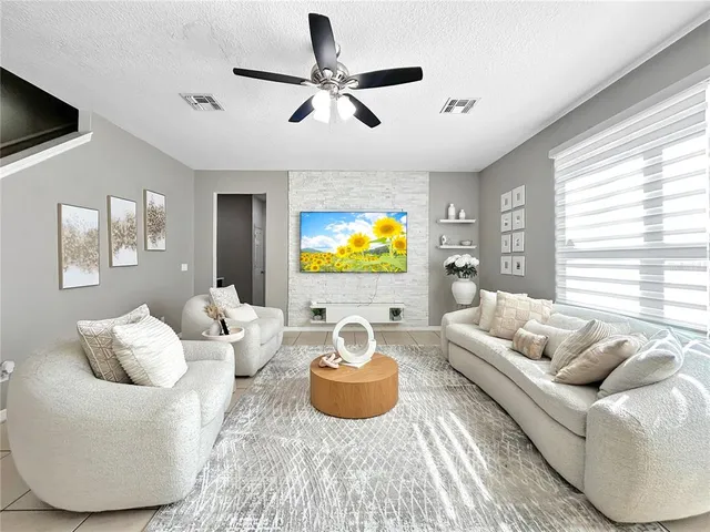 a living room with furniture and a flat screen tv