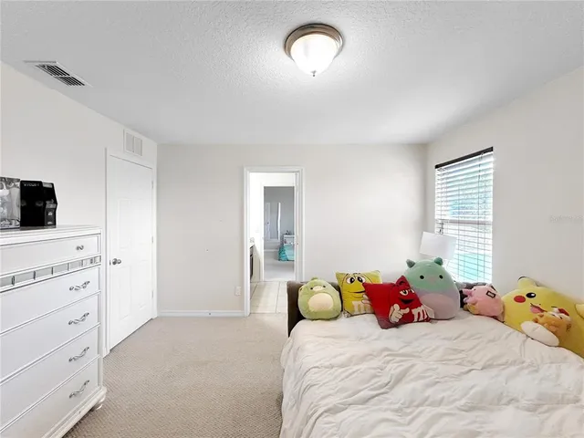 a bedroom with a bed and a tv