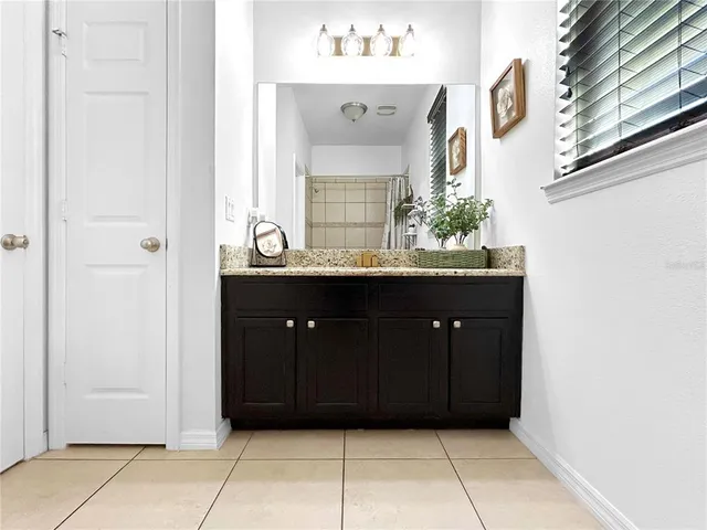 a bathroom with a sink vanity and a mirror