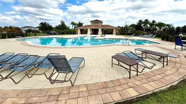 a view of a swimming pool with a lounge chair