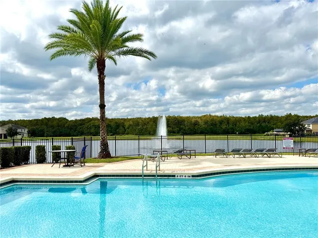 a view of swimming pool with seating space