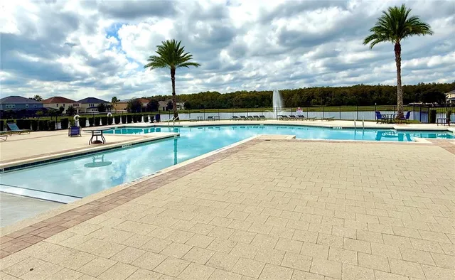 a view of swimming pool with outdoor seating