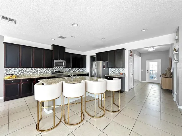 a large kitchen with a table and chairs