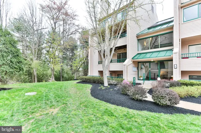 a view of an house with backyard space and balcony