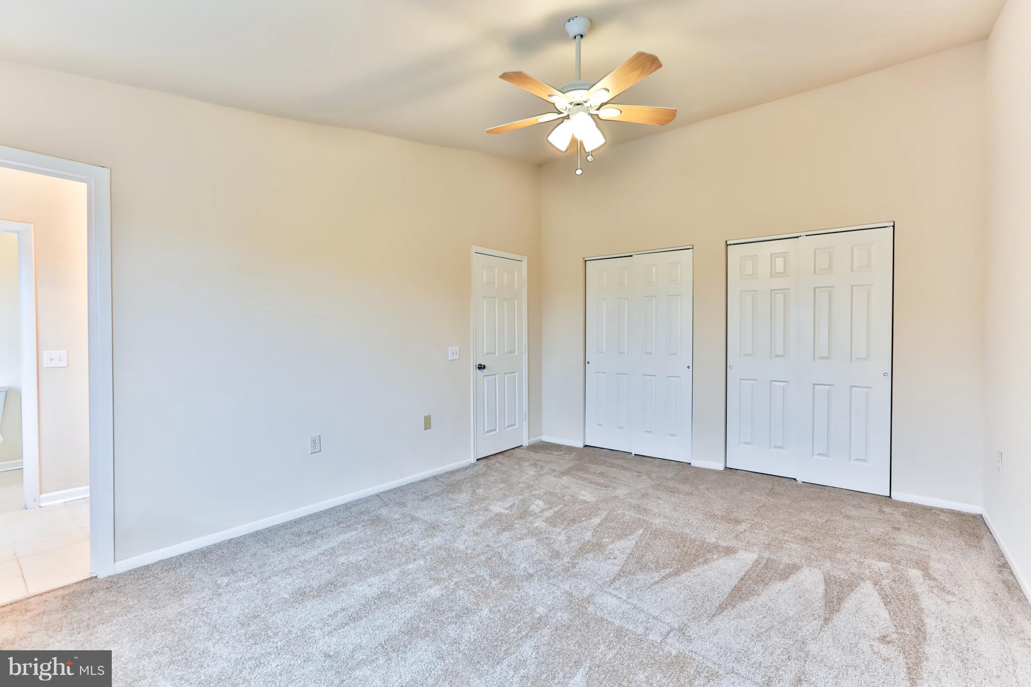 6 Winners Circle, Unit 3C Owings Mills, MD 21117 - Photo 17 of 26 a view of an empty room with a chandelier fan