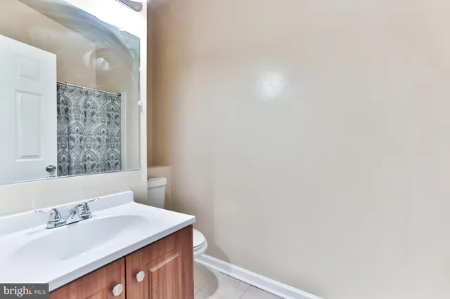 a bathroom with a sink vanity and a mirror