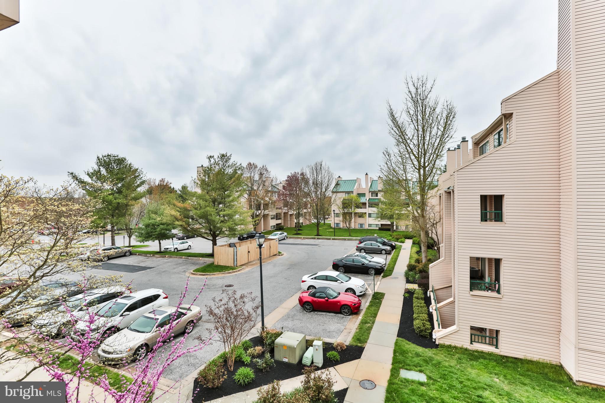 6 Winners Circle, Unit 3C Owings Mills, MD 21117 - Photo 25 of 26 a view of a backyard with couches plants and large trees