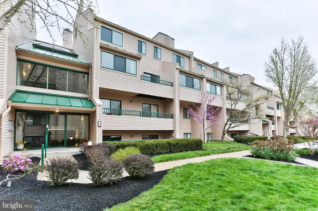 a front view of a building with a garden