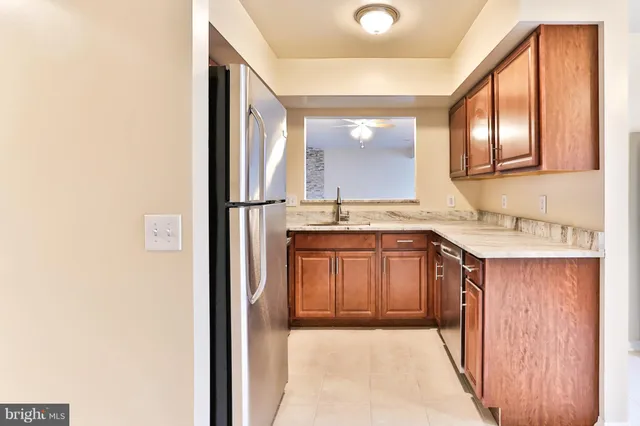a kitchen with a refrigerator sink and cabinets