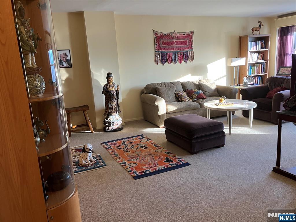 280 Prospect Avenue, Unit 11H Hackensack, NJ 07601 - Photo 4 of 20 a living room with furniture and a flat screen tv