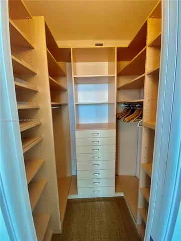 a bathroom with a granite countertop sink a toilet a mirror and shower