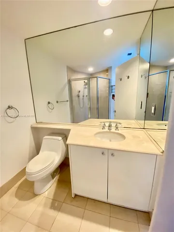 a bathroom with a glass shower door