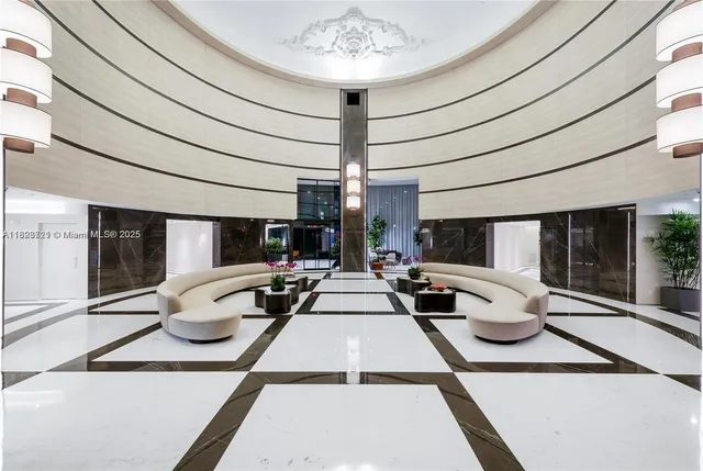 a living room with furniture and a floor to ceiling window