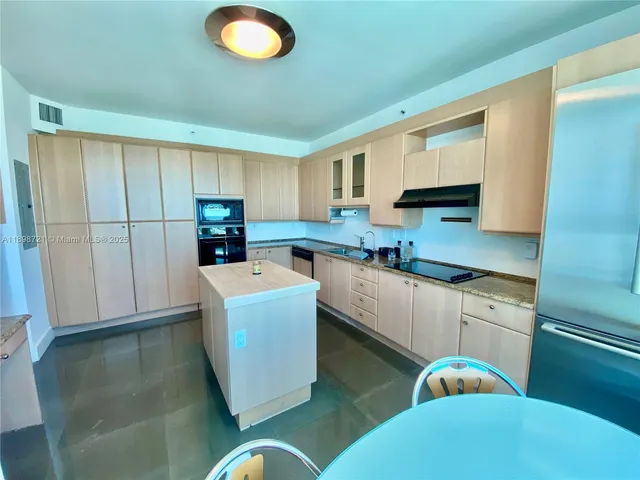 a kitchen that has a sink and a stove in it