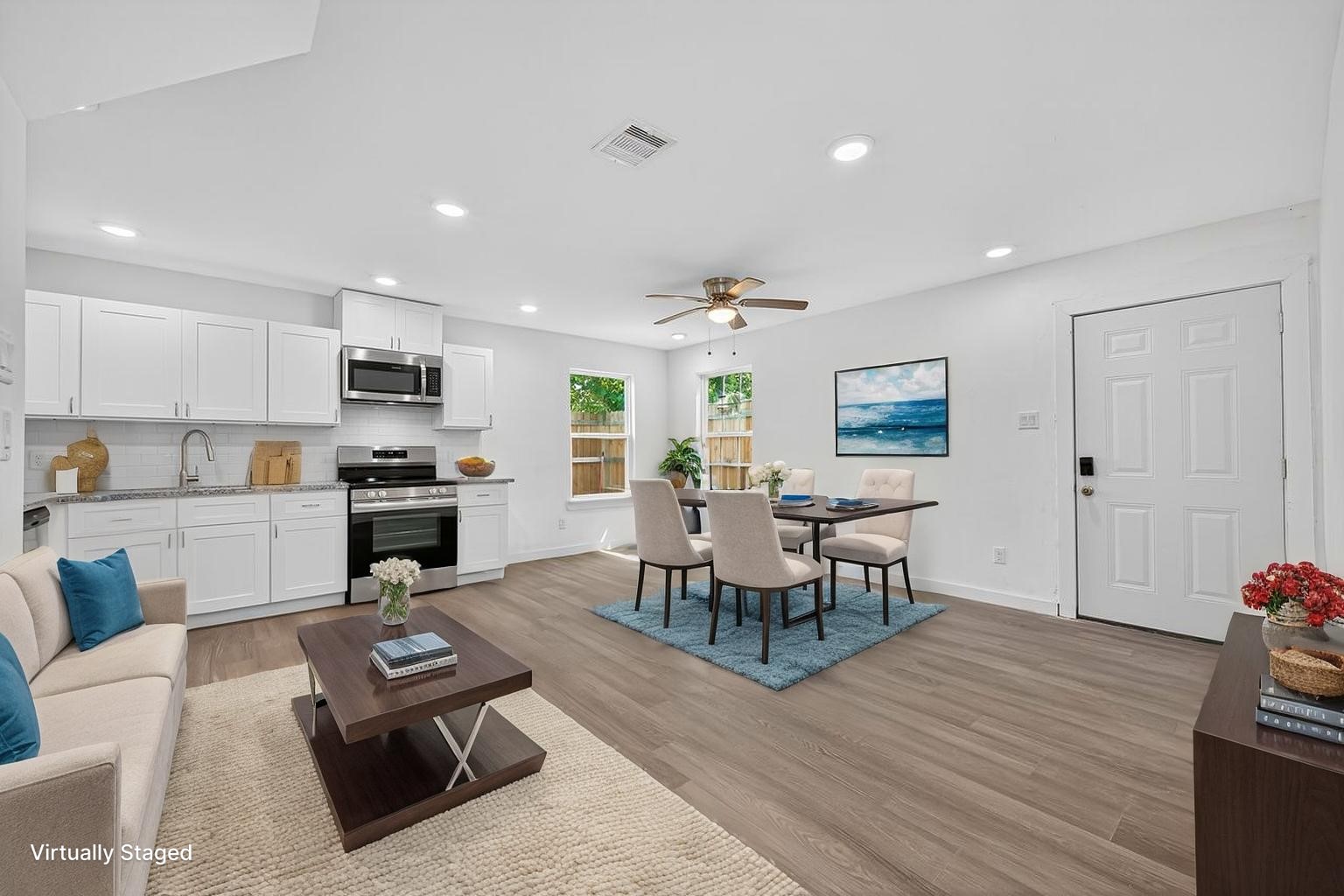 9405 Madera Road Houston, TX 77078 - Photo 1 of 32 a living room with furniture and a dining table with kitchen view