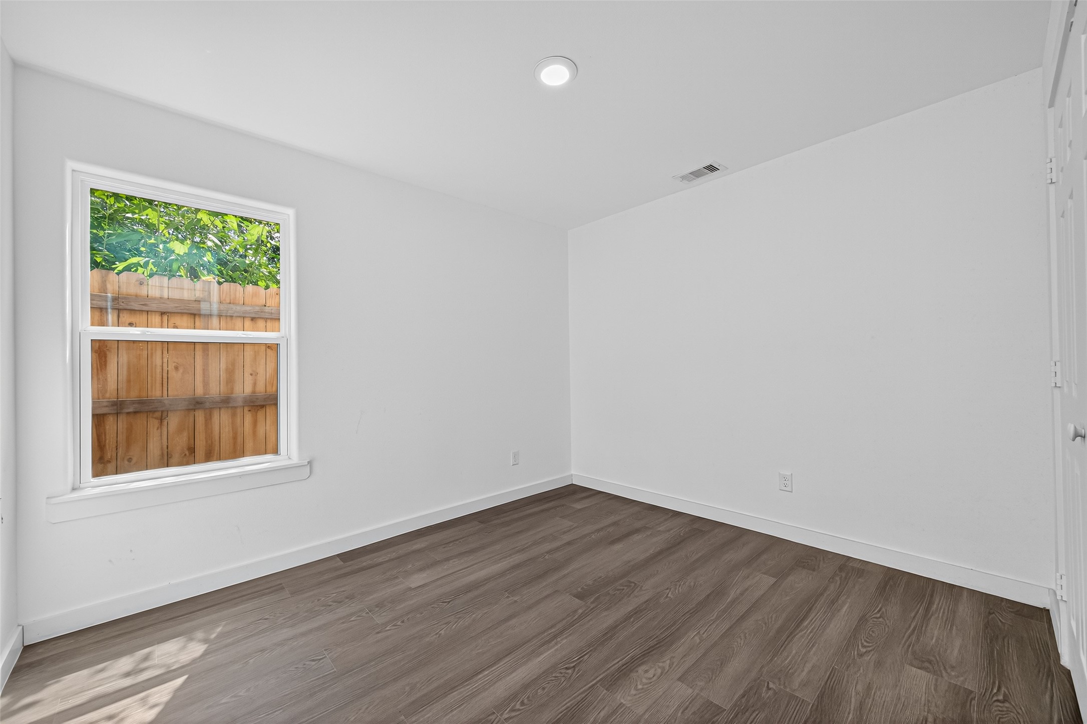 9405 Madera Road Houston, TX 77078 - Photo 13 of 32 wooden floor in an empty room with a window