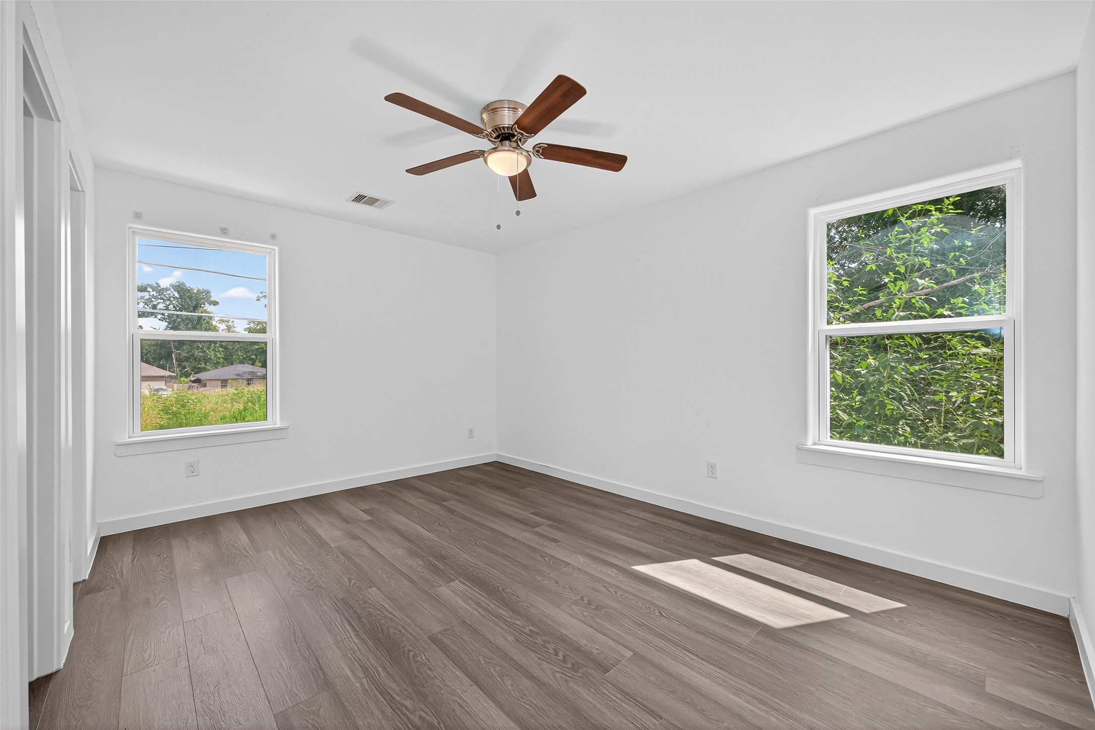 9405 Madera Road Houston, TX 77078 - Photo 17 of 32 a view of empty room with wooden floor and window