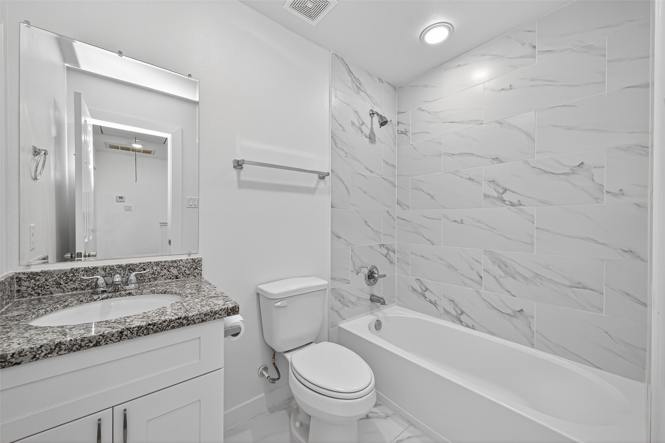 9405 Madera Road Houston, TX 77078 - Photo 27 of 32 a bathroom with a granite countertop sink a toilet and bathtub
