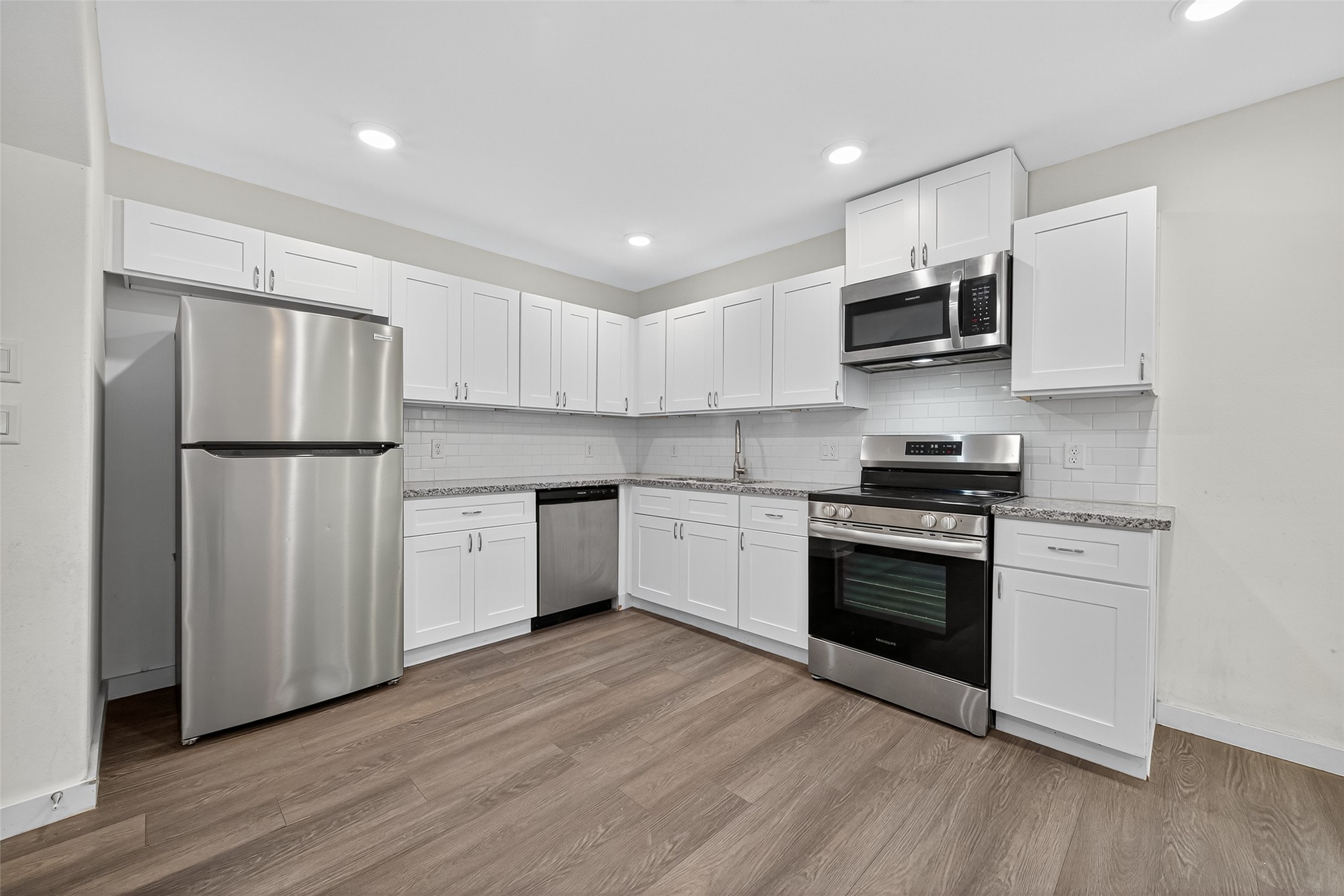 9405 Madera Road Houston, TX 77078 - Photo 8 of 32 a kitchen with stainless steel appliances a refrigerator sink and microwave