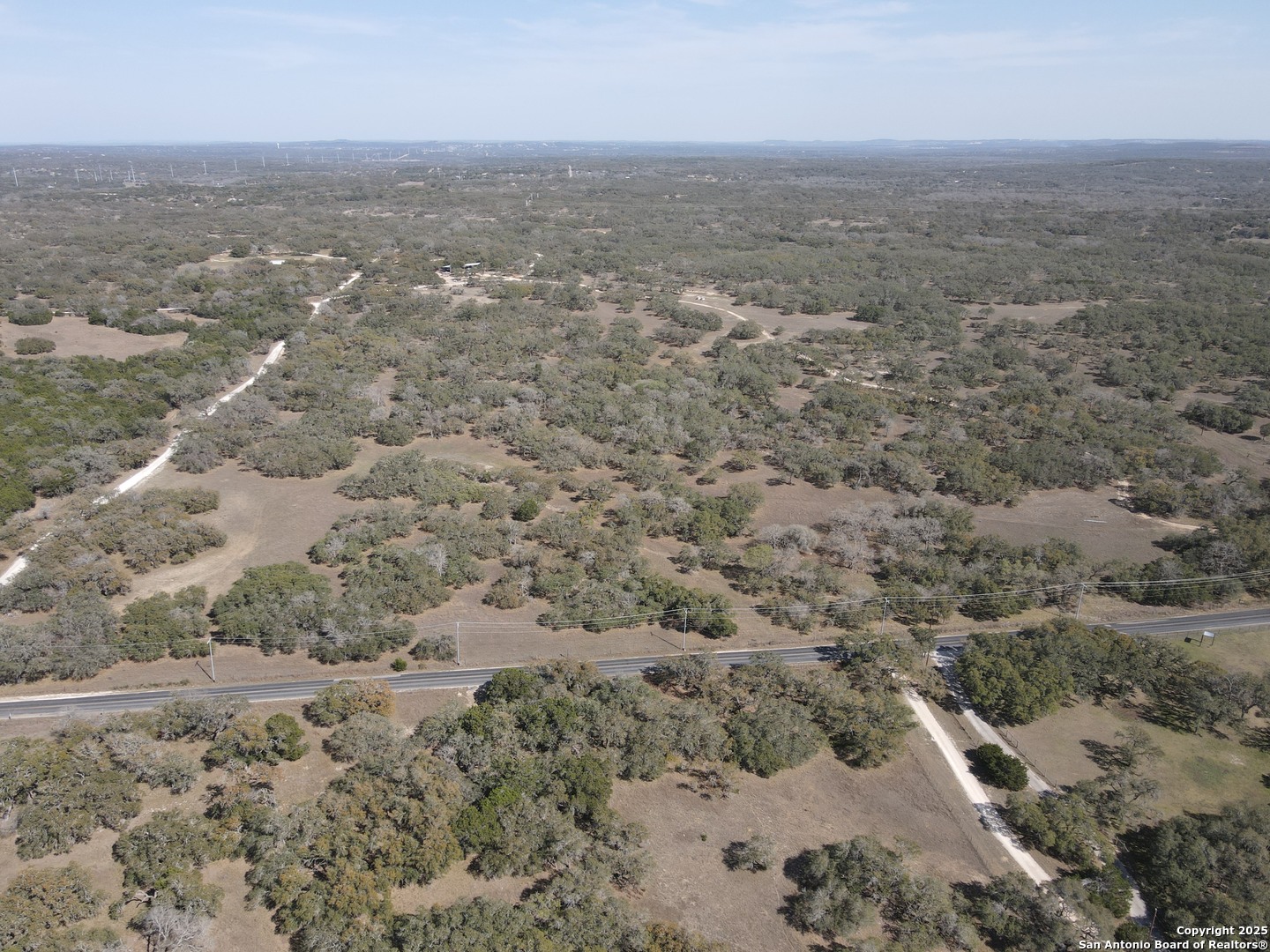 346 Ammann Road Boerne, TX 78015 - Photo 2 of 6 an aerial view of house with yard and mountain in the background