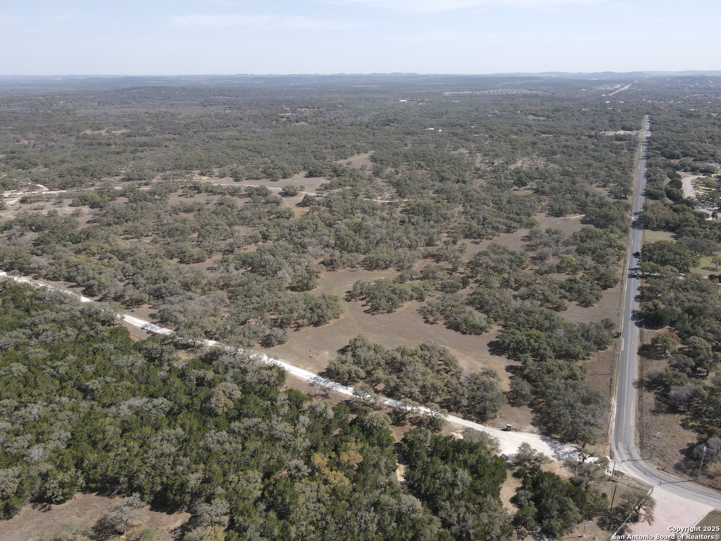 346 Ammann Road Boerne, TX 78015 - Photo 4 of 6 an aerial view of house with yard and mountain view in back