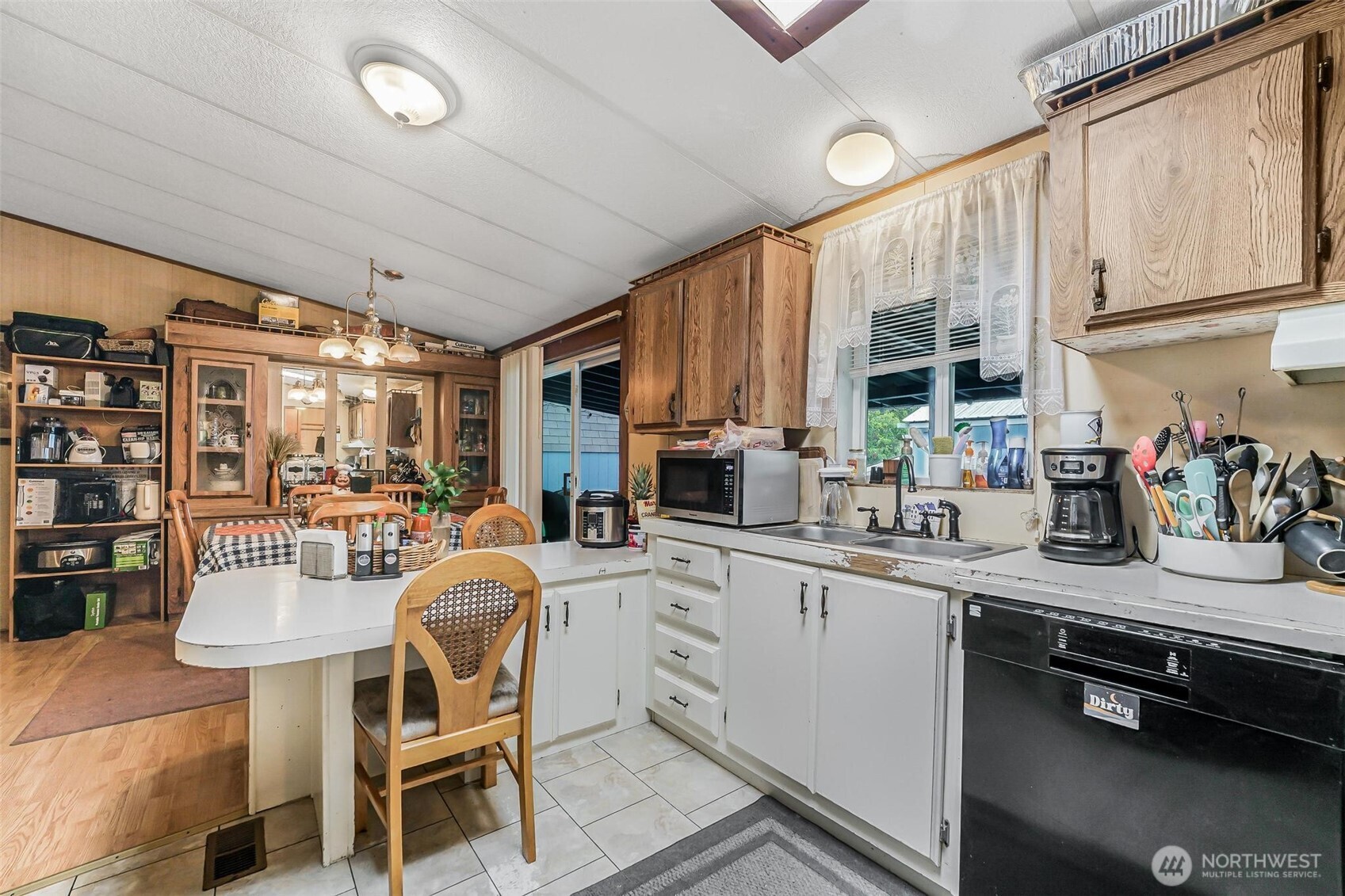 980 South Falcon Road Camano Island, WA 98282 - Photo 6 of 30 a kitchen with stainless steel appliances granite countertop a sink and cabinets