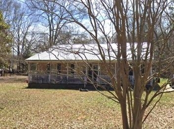 a view of a yard covered with snow in front of house