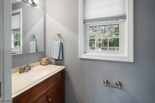 a bathroom with a sink vanity and a mirror