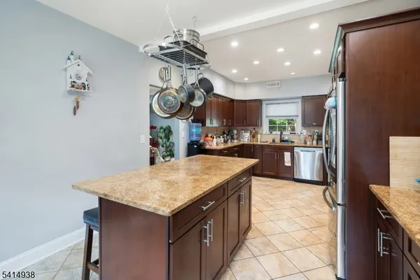 a kitchen with a sink a counter space and stainless steel appliances