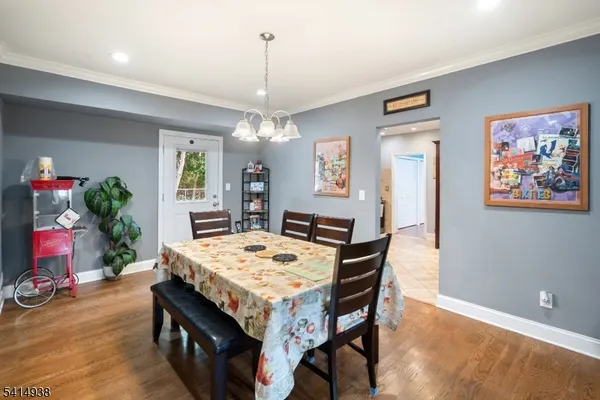 a view of a dining room with furniture and a chandelier