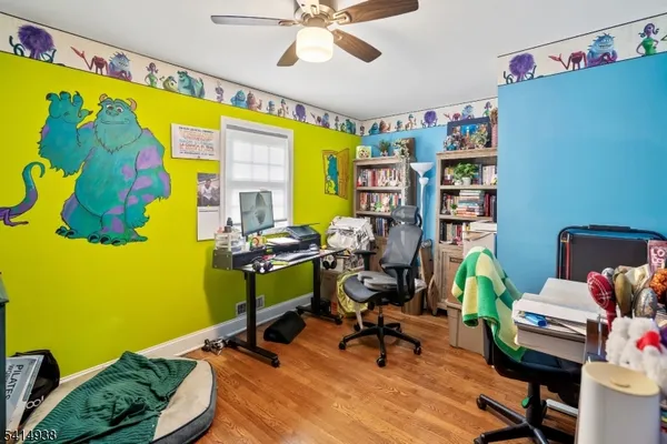 a work room with furniture and a potted plant