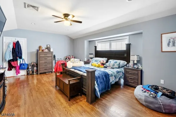 a bathroom with a toilet a sink a vanity and mirror