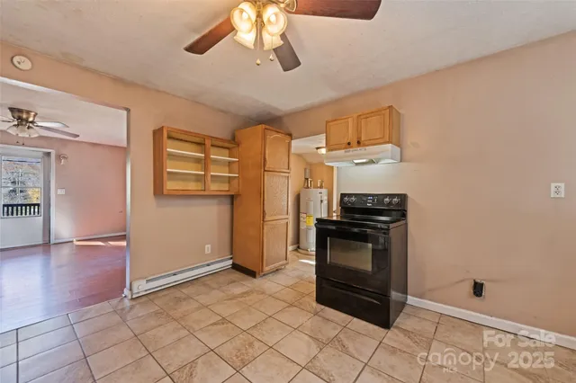 a kitchen with stainless steel appliances granite countertop a refrigerator a stove and a sink with wooden floor