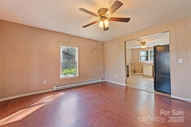 wooden floor in an empty room with a window