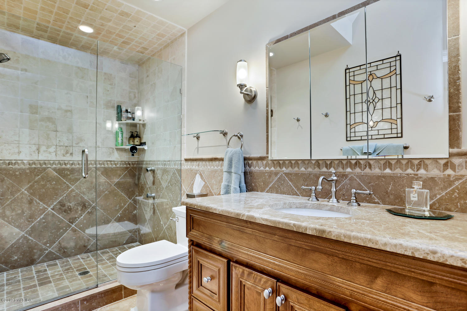 193 Hamilton Avenue, Unit 10 Greenwich, CT 06830 - Photo 14 of 22 a bathroom with a granite countertop sink a toilet a mirror and shower