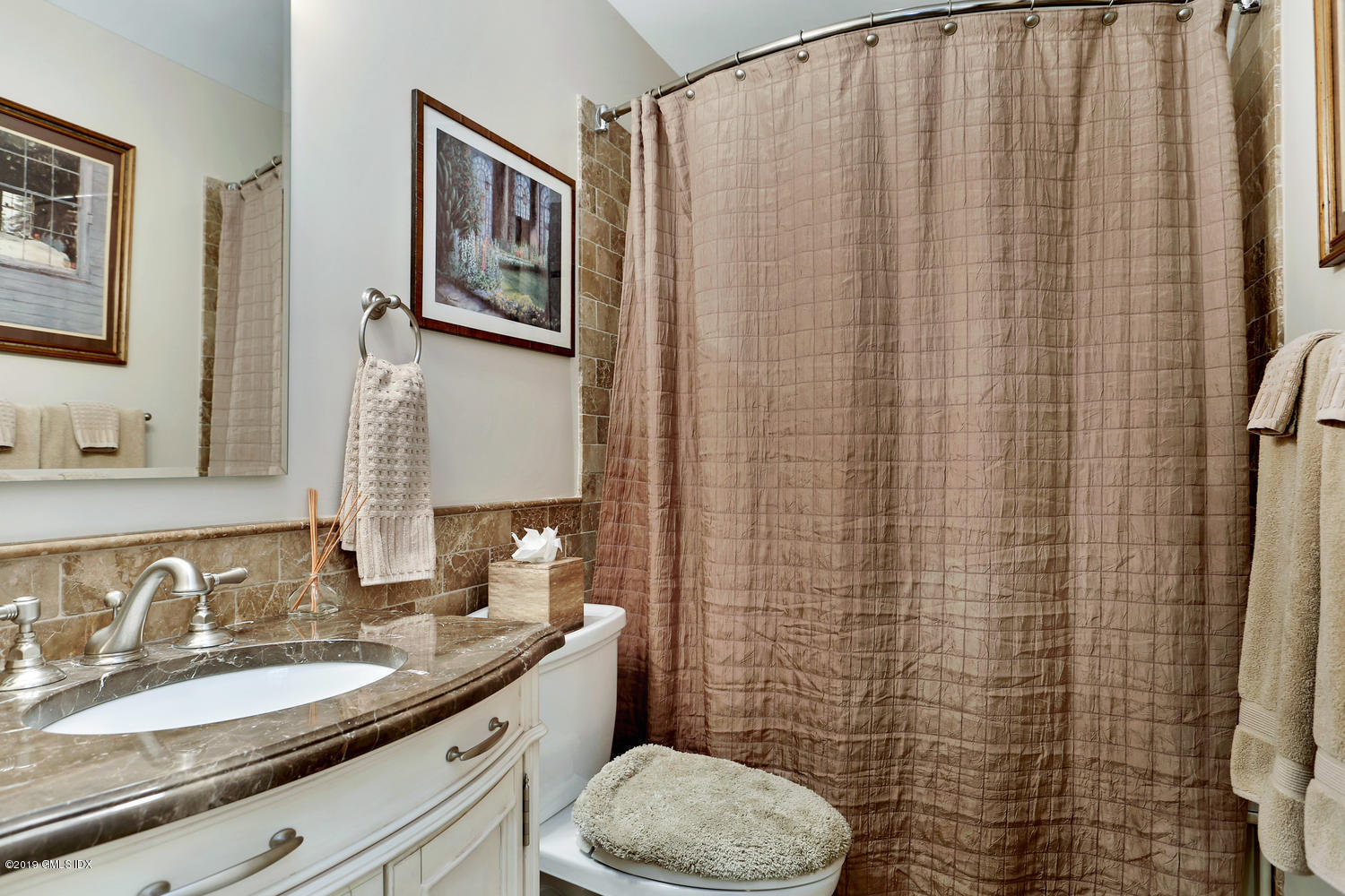 193 Hamilton Avenue, Unit 10 Greenwich, CT 06830 - Photo 15 of 22 a bathroom with a granite countertop toilet sink and a mirror