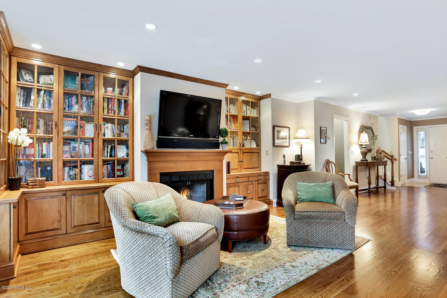 193 Hamilton Avenue, Unit 10 Greenwich, CT 06830 - Photo 4 of 22 a living room with fireplace furniture and a flat screen tv