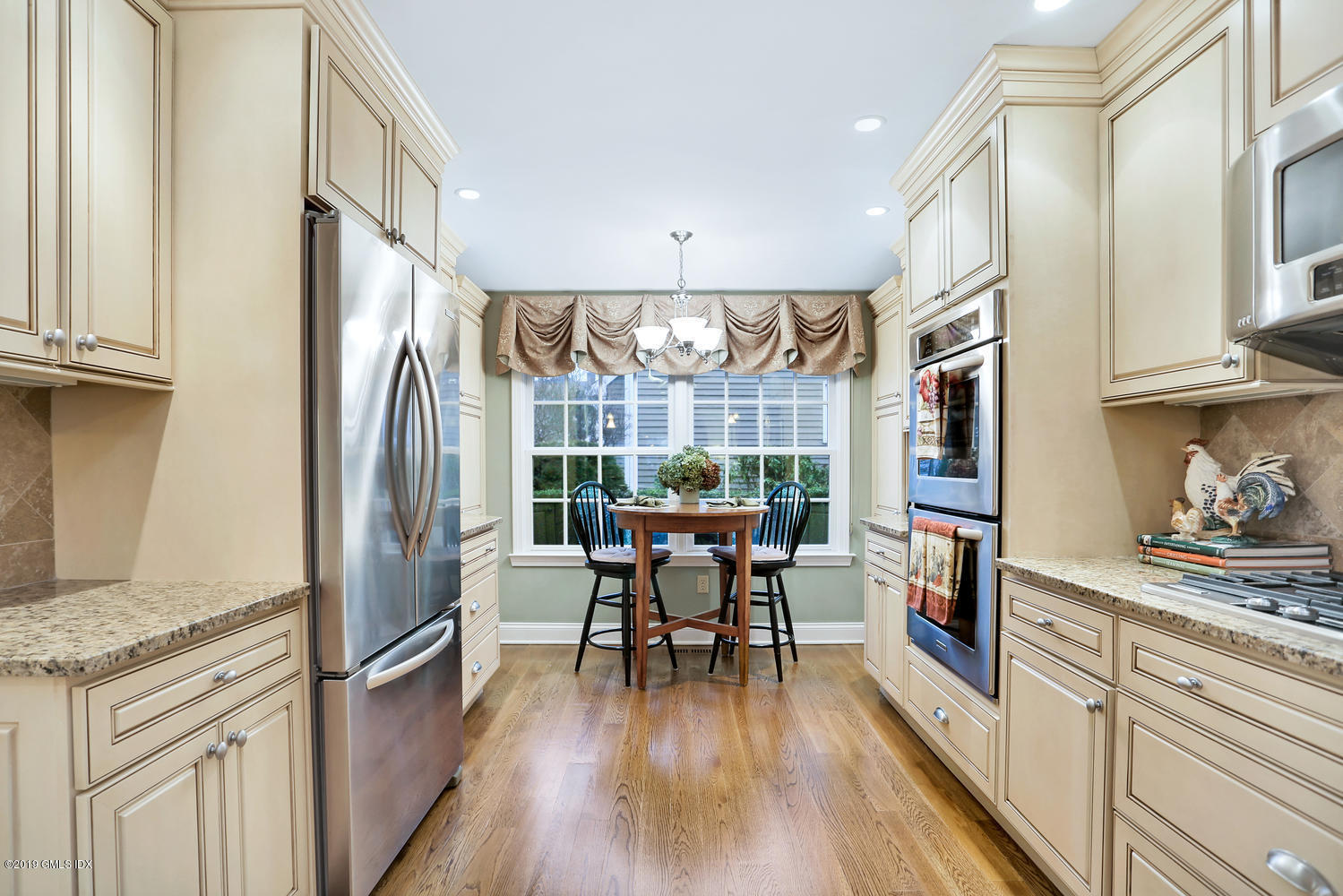 193 Hamilton Avenue, Unit 10 Greenwich, CT 06830 - Photo 8 of 22 a kitchen with stainless steel appliances granite countertop a refrigerator and wooden floor